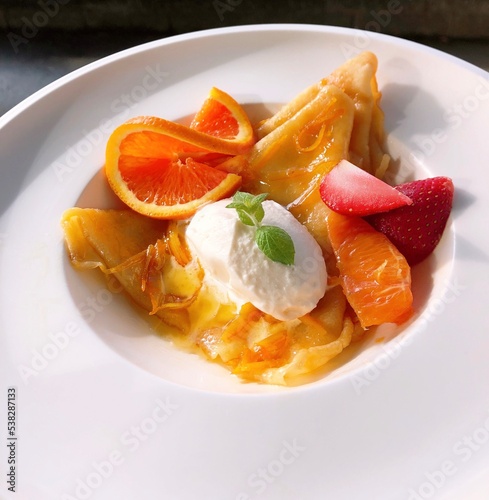 Crêpes Suzette (French dessert consisting of crêpes with beurre Suzette, a sauce of caramelized sugar and butter, tangerine or orange juice, zest, and Grand Marnier)