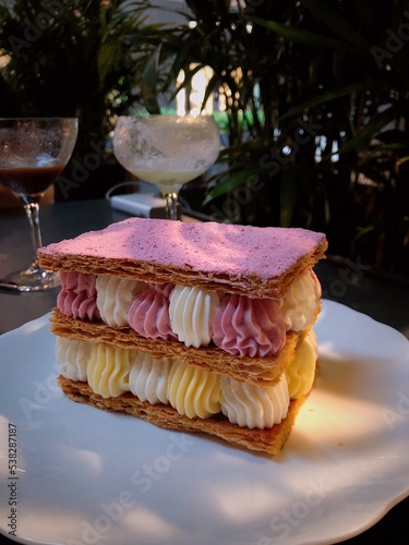 Mille-feuille raspberry chantilly dessert on a white plate