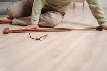 Asian senior man falling on the ground with walker in living room at home. Elderly older mature male having an accident heart attack for emergency help support from hospital. Insurance health care.