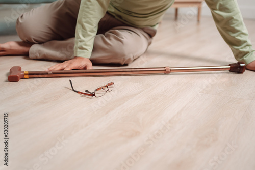 Принти на полотні Asian senior man falling on the ground with walker in living room at home