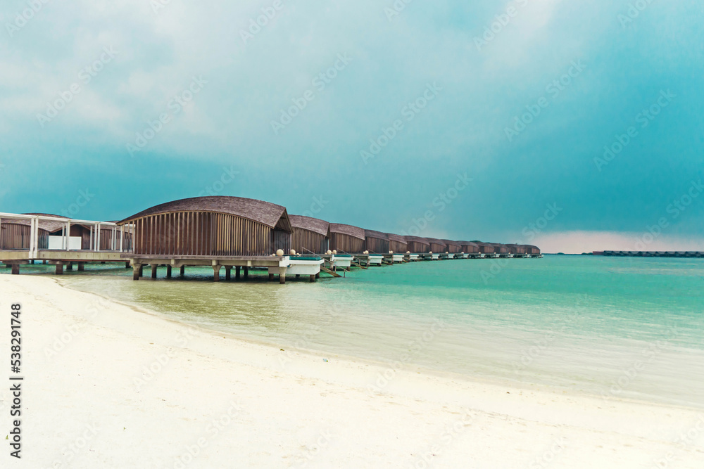 Exotic wooden villa on the water at Club Med Finolhu, a resort located on a very quiet and comfortable small island in the Maldives with stunning sea views	