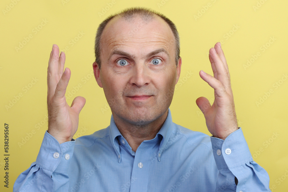 Portrait of a satisfied and enthusiastic man with his hands up. Portrait of a satisfied and enthusiastic man with his hands up.