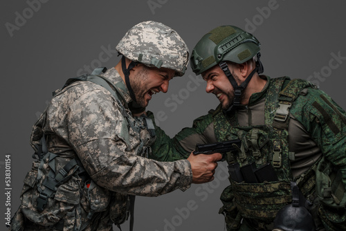 Photo of angry soldiers and their confrontation against grey background.