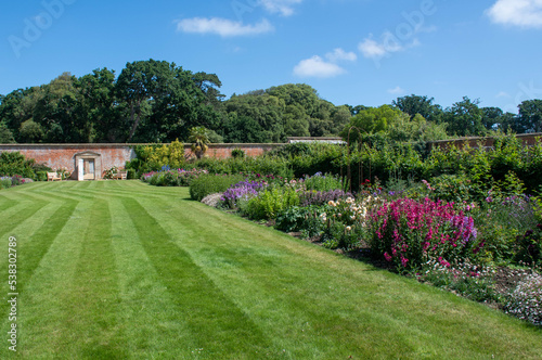 English walled garden with flowers and lawn