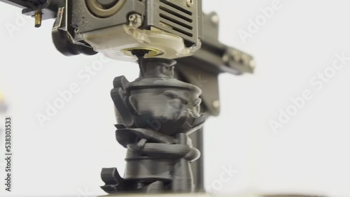 The 3D printer is working on printing a giant figure.