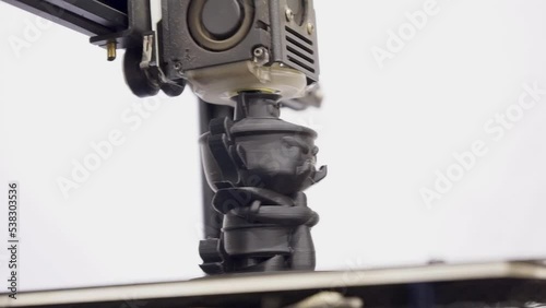 The 3D printer is working on printing a giant figure.