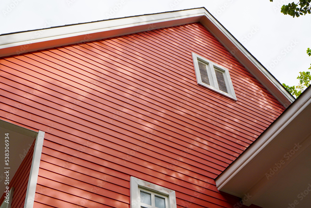 red decorative wooden wall panel of the house for outdoor ,selective focus on the wall red decorative wooden wall panel of the house for outdoor ,selective focus on the wall