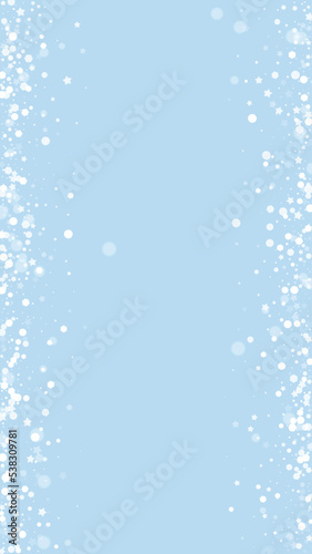 Magic falling snow christmas background. Subtle flying snow flakes and stars on light blue winter backdrop. Magic falling snow holiday scenery.   Vertical vector illustration.