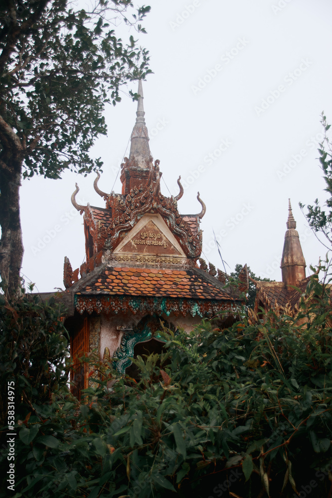 Fog gently covering Wat Sampov Pram Temple on top of the Bokor Mountains in Kampot, Cambodia
