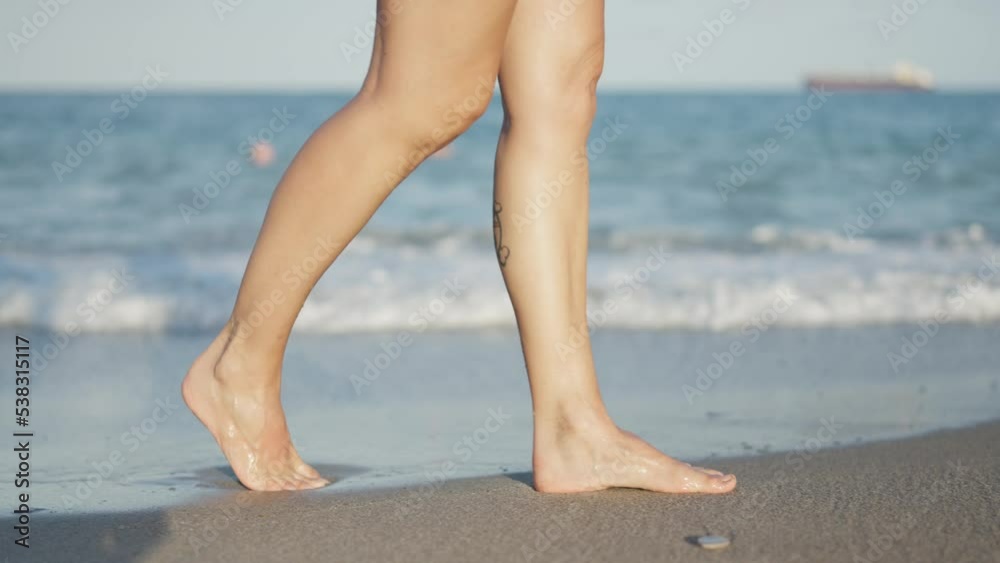 Slow motion video of feet walking through sea water Slow motion video of feet walking through sea water