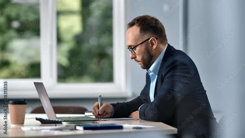 Male boss working office desk making notes reminder agenda use laptop prepare to business conference Male boss working office desk making notes reminder agenda use laptop prepare to business conference
