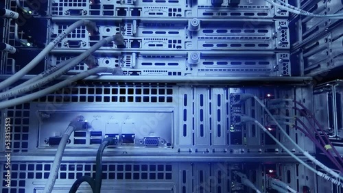 Close-up view of modern internet network switch Network dark server room with fiber optic hub.