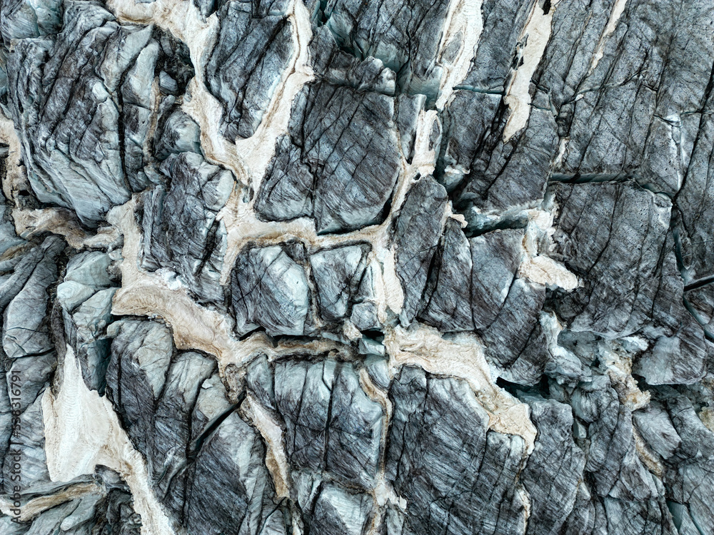 Glacial glacier white and blue ice texture structure top down aerial view Glacial glacier white and blue ice texture structure top down aerial view