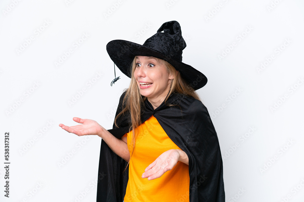 Young blonde woman dressed as a witch isolated on white background with surprise facial expression Young blonde woman dressed as a witch isolated on white background with surprise facial expression