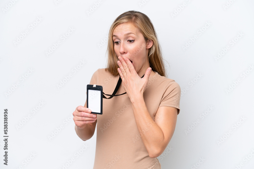 Young blonde woman with ID card isolated on white background with surprise and shocked facial expression Young blonde woman with ID card isolated on white background with surprise and shocked facial expression