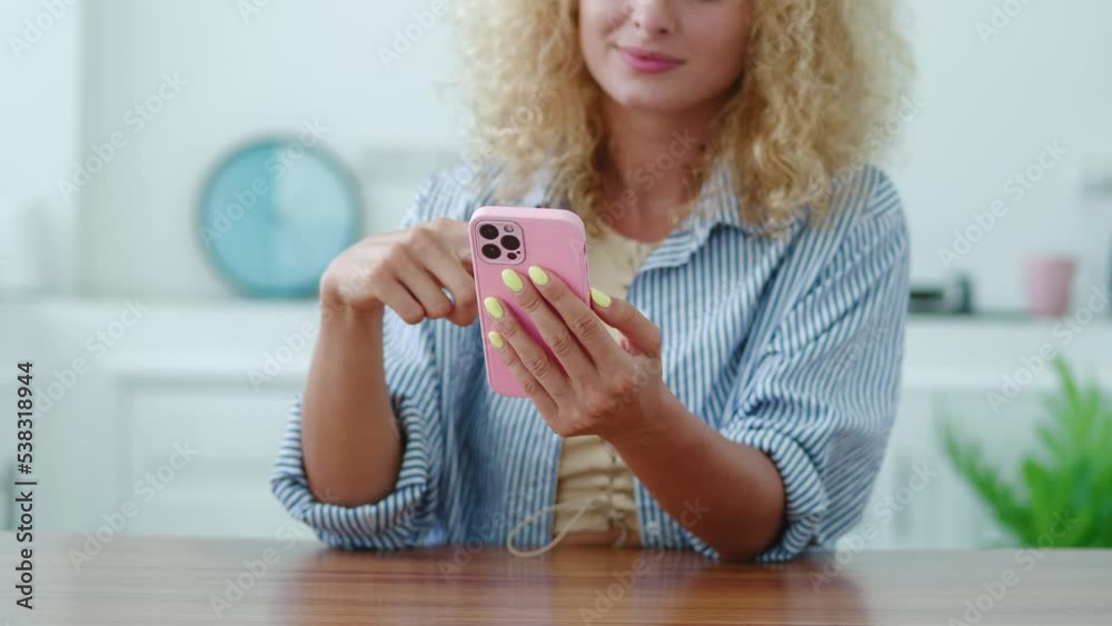 Selective focus on a modern smartphone in the hands of a pretty woman scrolling news feed, swiping right and left, up and down on the mobile phone screen touch. Selective focus on a modern smartphone in the hands of a pretty woman scrolling news feed, swiping right and left, up and down on the mobile phone screen touch.