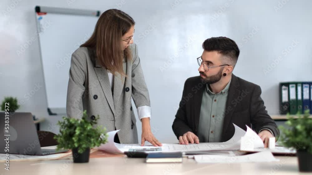 Woman architecture designer consulting to boss paper blueprint discussing project development Woman architecture designer consulting to boss paper blueprint discussing project development