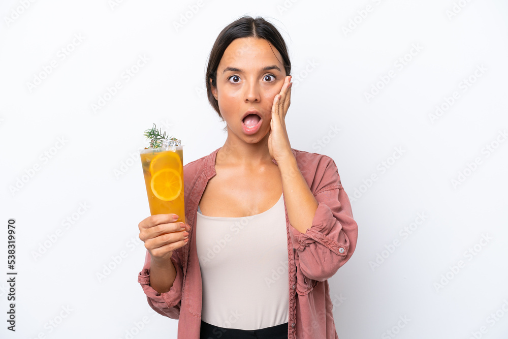 Young hispanic woman holding a cocktail isolated on white background with surprise and shocked facial expression Young hispanic woman holding a cocktail isolated on white background with surprise and shocked facial expression