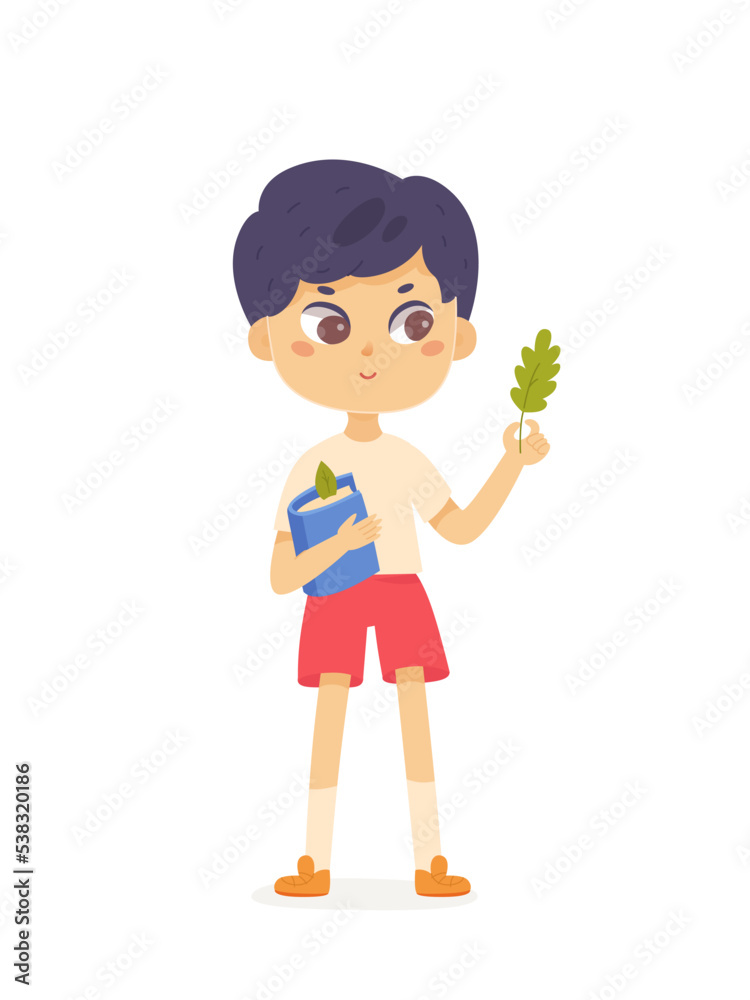 Smart boy school student holding book and green leaf of tree in hand to study nature Smart boy school student holding book and green leaf of tree in hand to study nature