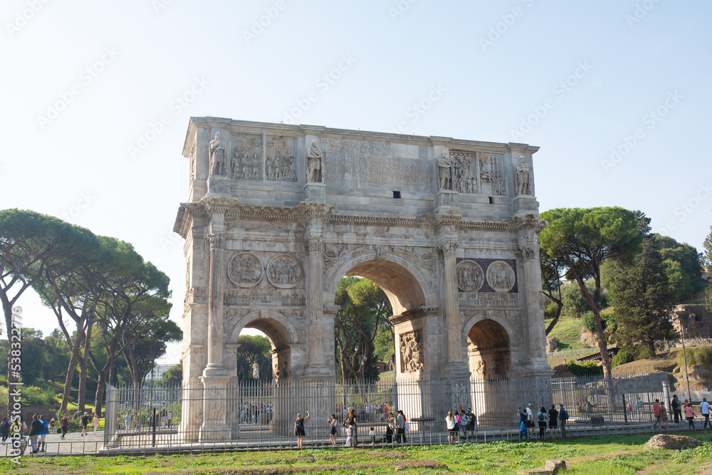 A landscape view of the Arch of Constantine in sunny holidays, lots of tousists, summer vacation, Rome, Italy.