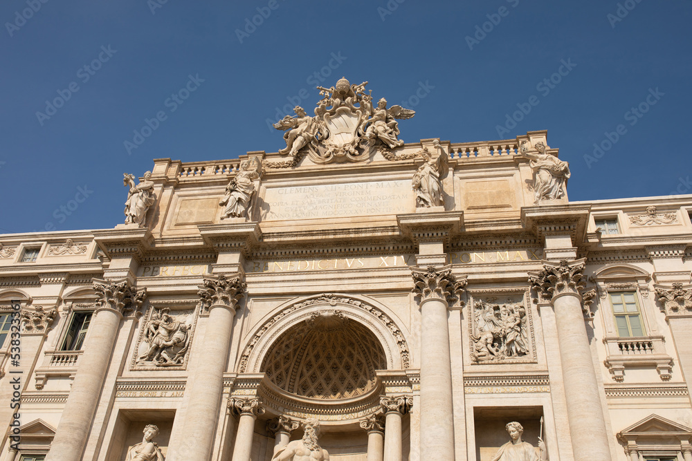 Obraz premium Trevi Fountain in Rome, Italy. Ancient fountain. Roman statues at piazza in old medieval city among traditional italian houses and street lamps. Famous landmark.