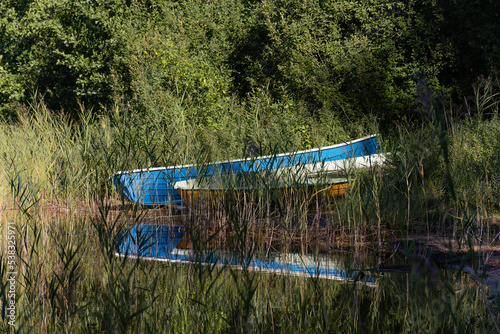 Two rowing boats on a sandy beach among the reeds in Repovesi National Park, Finland