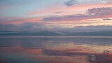 Stunning panoramic view of bay against horizon with sunset and orange sky under dense moving clouds.