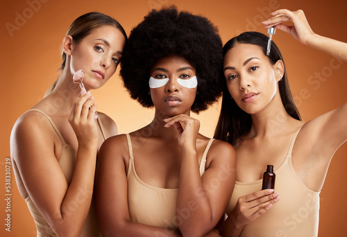 Beauty, diversity and skincare with model woman friends in studio on a brown background for cosmetics or wellness. Skin care, together and inclusion with a female group posing for health or beauty
