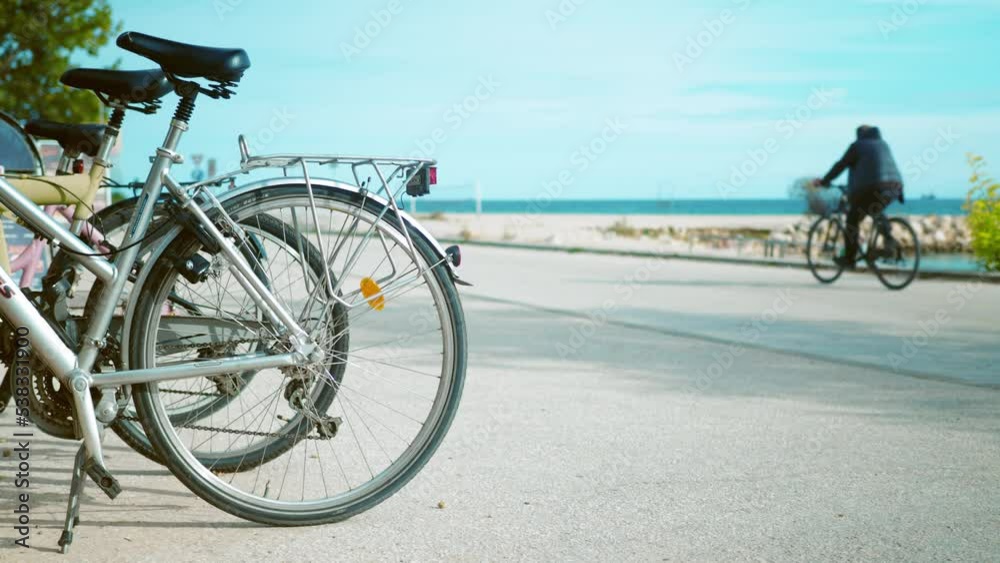 Riding the bike path on sea beach. Bicycle parking. Zero emissions city Riding the bike path on sea beach. Bicycle parking. Zero emissions city