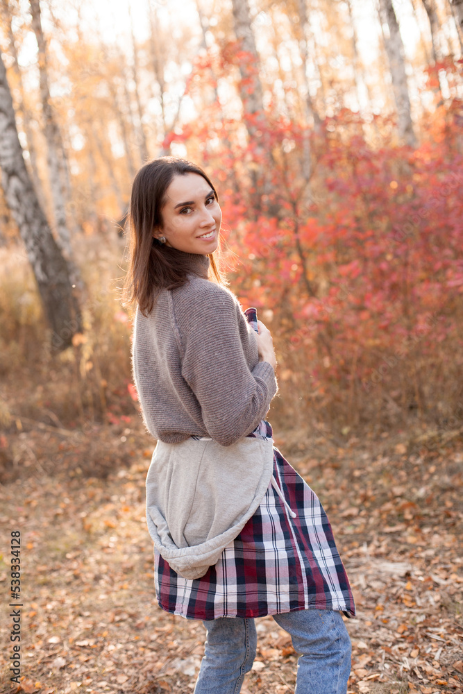 Beautiful young woman walking in the forest. Back Beautiful young woman walking in the forest. Back