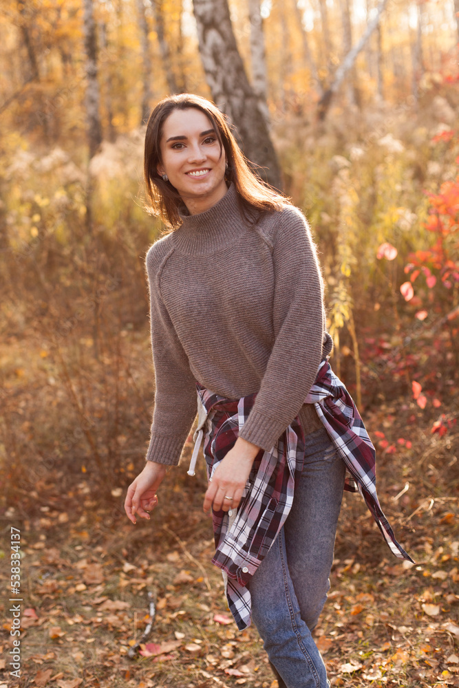 Happy young woman walking in autumn forest. Happy young woman walking in autumn forest.