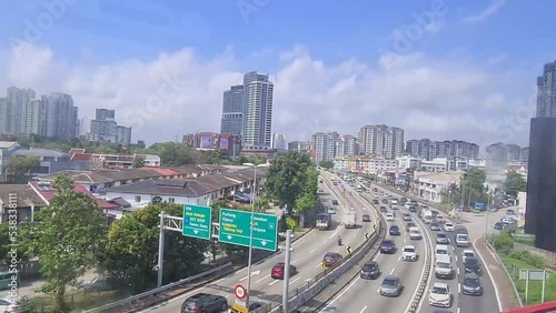 Someone looking at buildings on a busy road and sky from train window photo