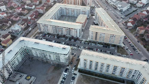 Residential block of high rise apartment buildings made of concrete in a big city in Europe - triangle shaped flat complex in urban environment. Aerial drone view of Podgorica Montenegro. photo