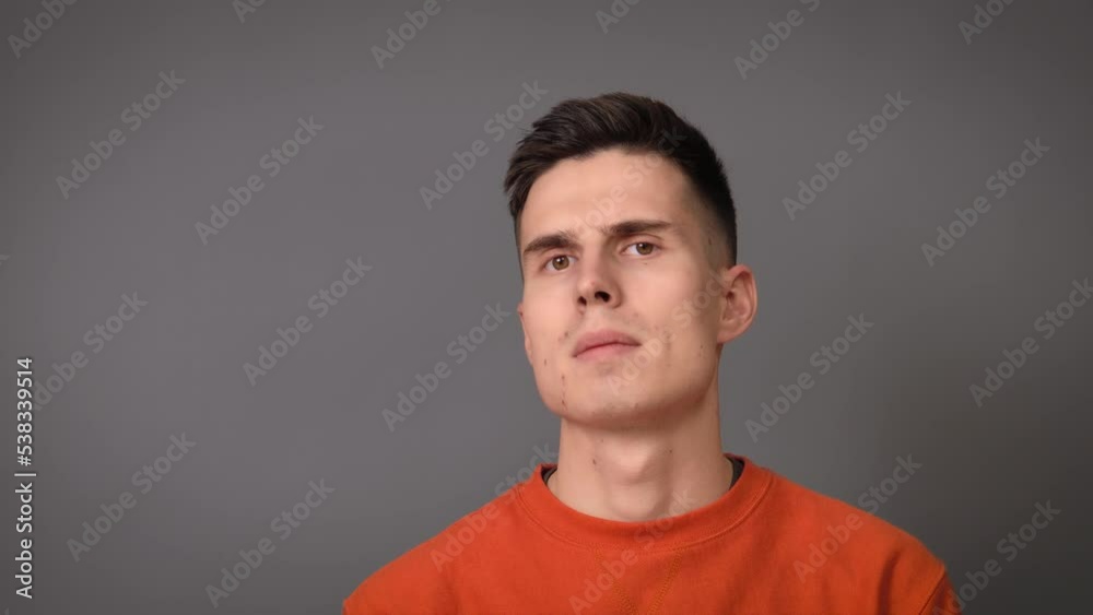 Portrait of a man who shows surprised emotions on a gray background Portrait of a man who shows surprised emotions on a gray background
