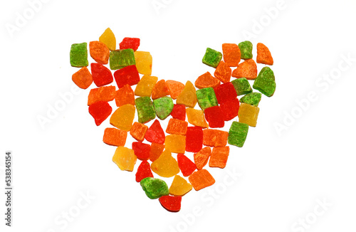 Colored candied fruits laid out in the shape of a heart photo