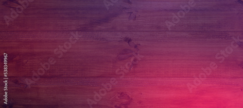 Background or texture of a wooden board in neon light