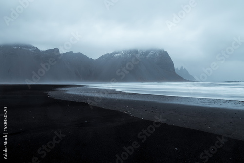 Mountains over black sand beach