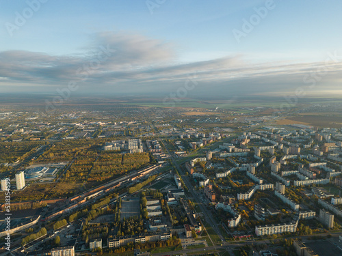 Aerial panorama of the city. The city in the warm light of the sunrise. Bird's-eye view. Aerial photography. A picture from a drone.