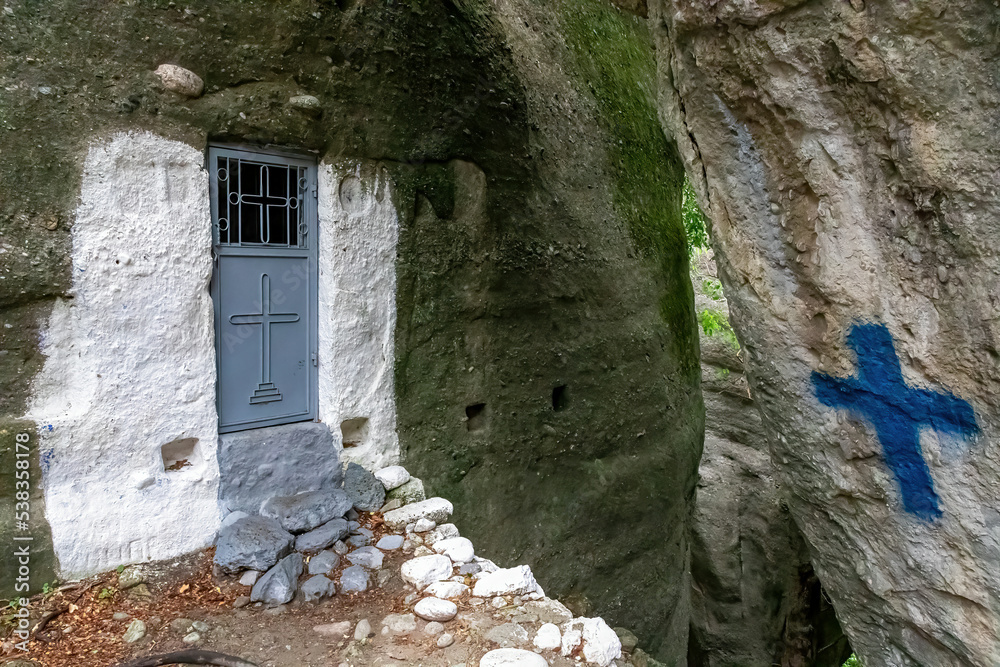 The small chapel carved into the rock on the footpath to the rock Holy Spirit (Agio Pnevma) in Kastraki, Meteora, Kalambaka, Thessaly, Greece, Europe. Hiking through Meteora hermit caves