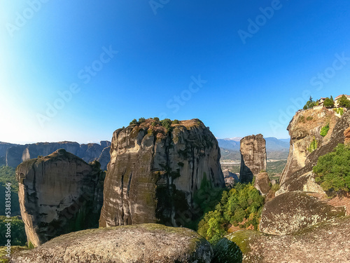 Panoramic view of steep canyons of rock formations of the complexes of Eastern Orthodox monasteries in Kalambaka, Meteora, Thessaly, Greece, Europe. unique cliffs and dramatic landscape, freedom vibes © Chris