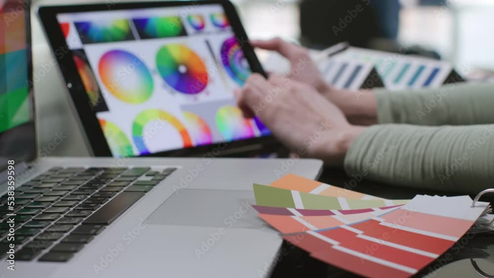 Close up of designer study color palette on digital tablet sitting at desk