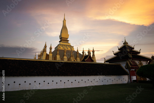 Laos Travel Landmark, Golden Chedi, Wat Phra That Luang at sunset in Vientiane