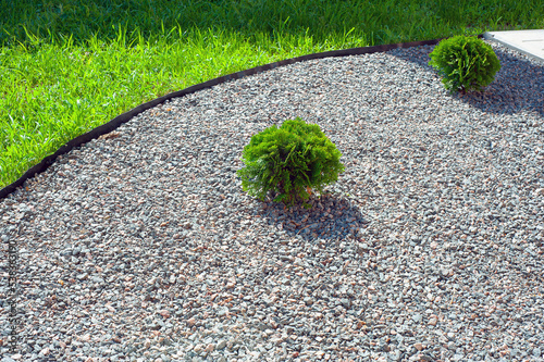mulching flower beds with marble stone. Stone chips for landscaping.