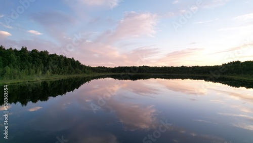 float over the lake and are reflected in the water.