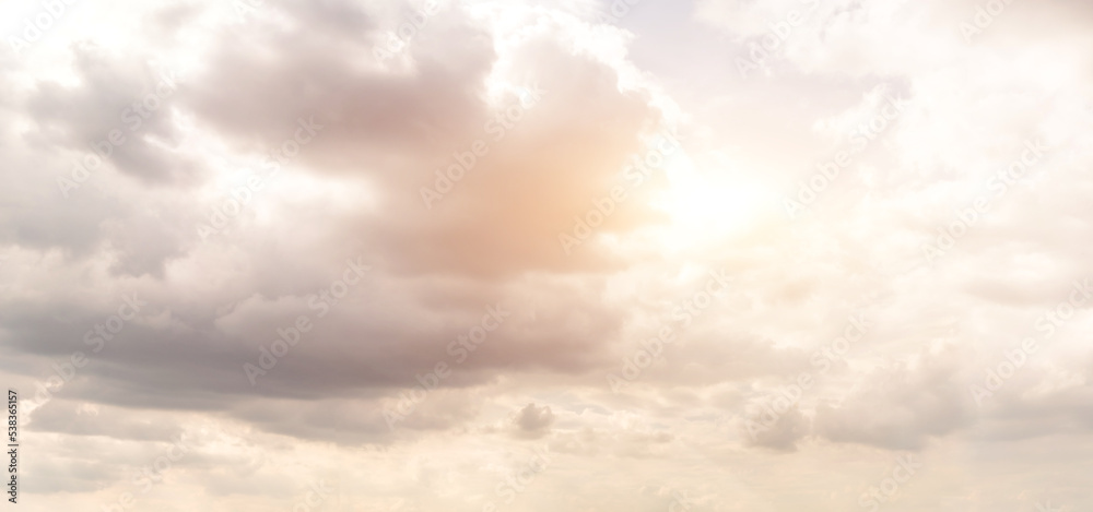 Beautiful sky background. Clouds block the sunlight and shine through
