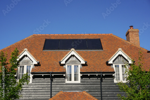 house roof top with solar panels. green energy concept. 