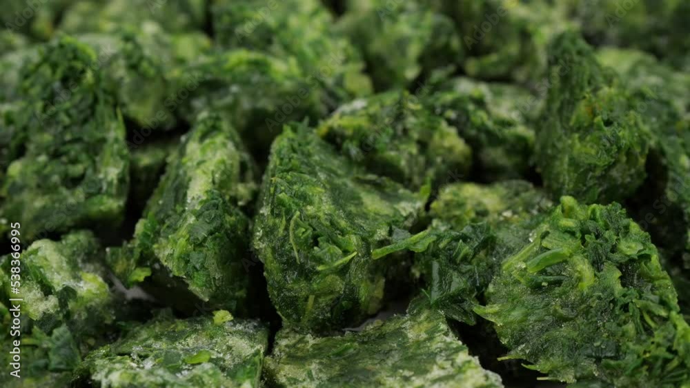 Frozen Spinach cubes close up, rotation. Ingredient for salad, soup, healthy food Frozen Spinach cubes close up, rotation. Ingredient for salad, soup, healthy food