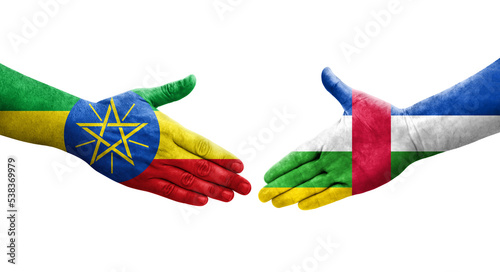 Handshake between Central African Republic and Ethiopia flags painted on hands, isolated transparent image.