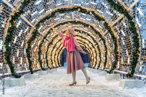 New Year's photos of a beautiful girl in the forest with a decorated Christmas tree, filled with comfort and magic
