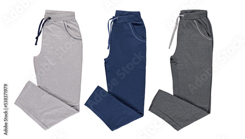 Collection of mens colored trousers on a white background. Isolated image on a white background. Nobody. 